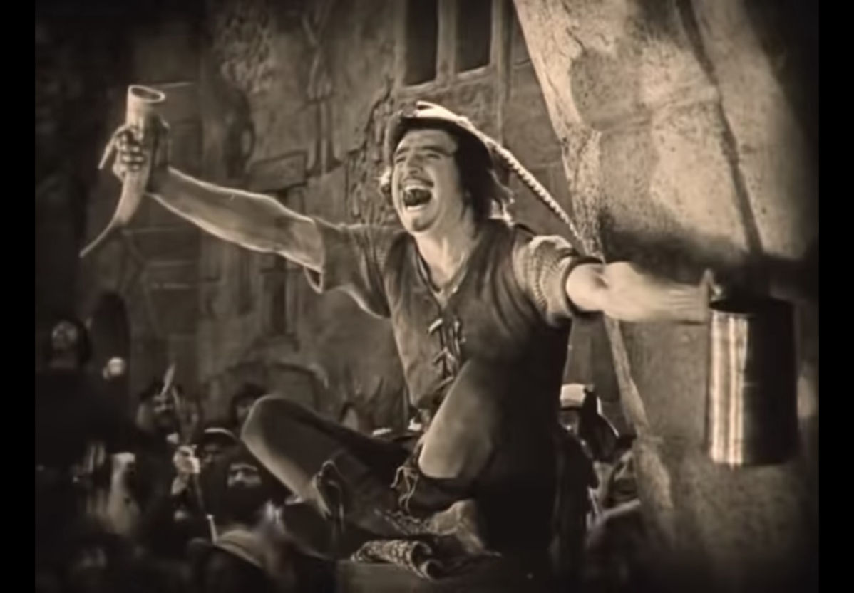 Douglas Fairbanks in Robin Hood celebrates a victory