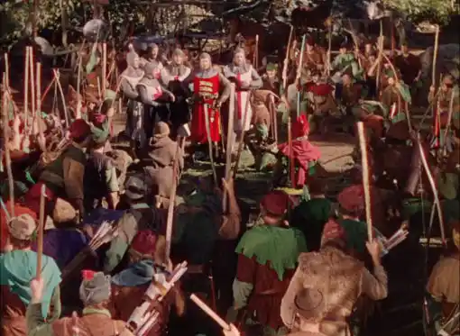 Errol Flynn's Robin Hood kneeling before the king in the 1938 film