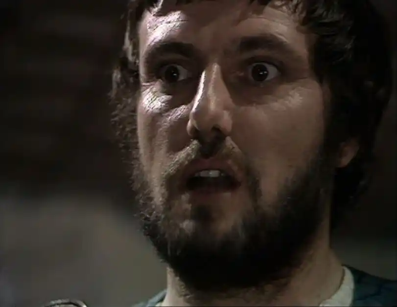 Darrow as the Sheriff with an odd expression