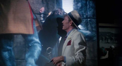 A drunken Alan Swann (actor Peter O'Toole) watches his old movie